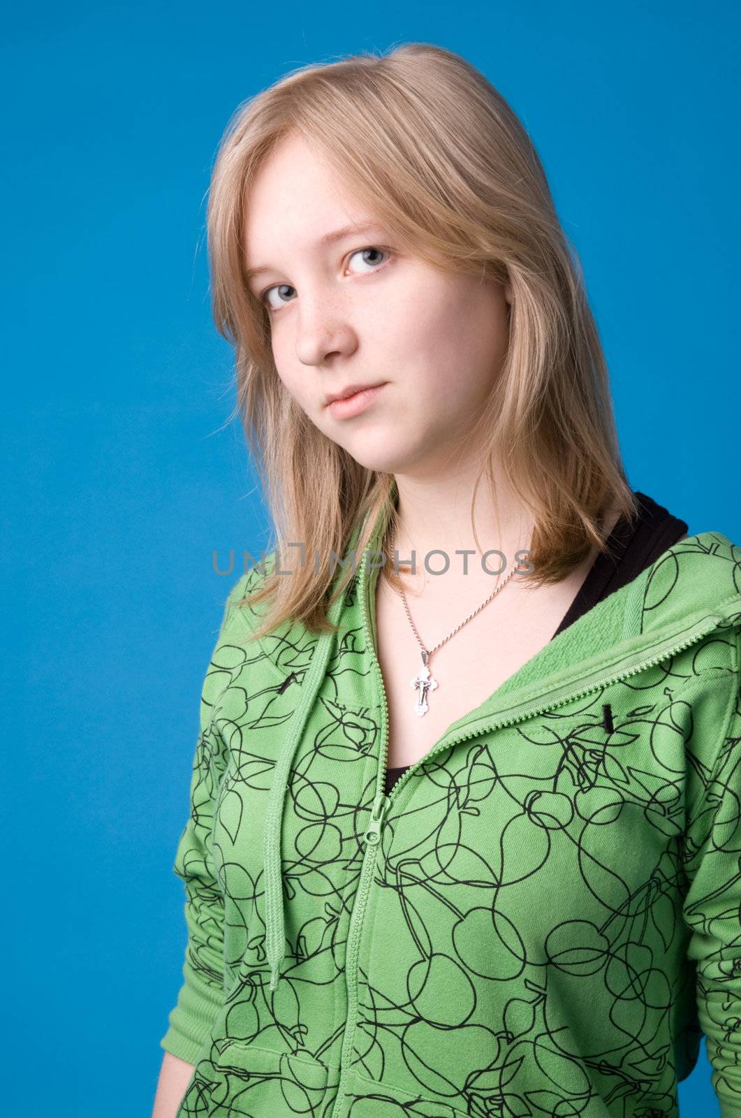 The young girl in green clothes on a dark blue background.