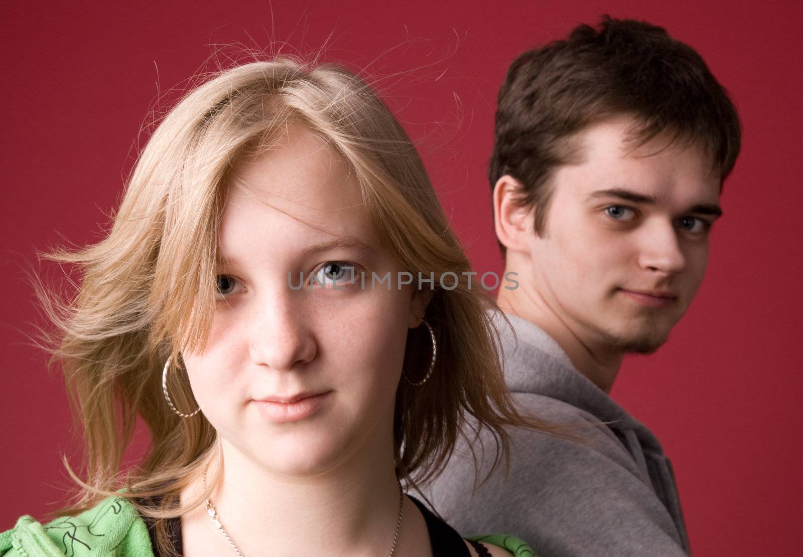 The young girl and the guy on a red background.