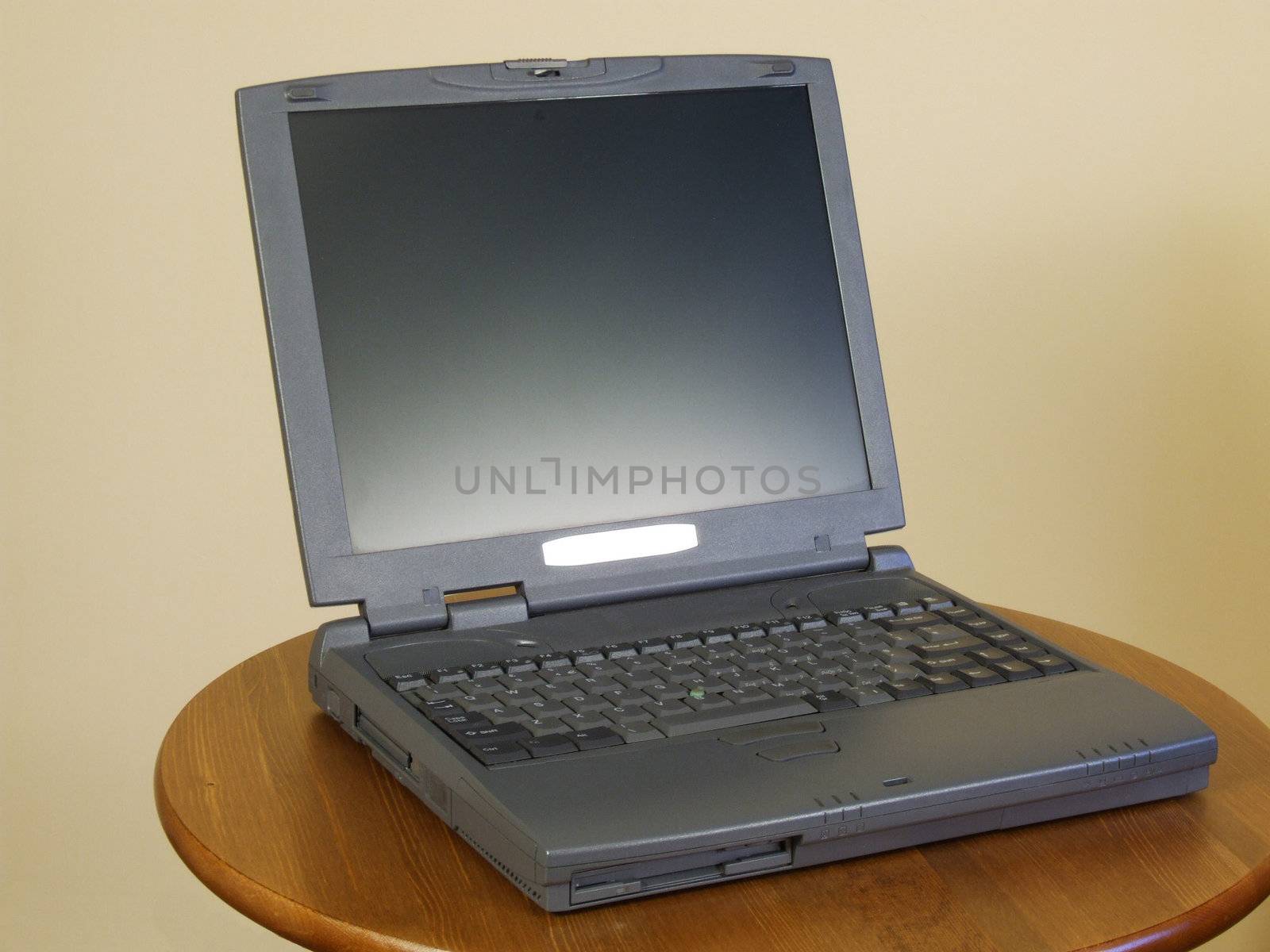 Typical notebook with silver screen. Computer on a table.
