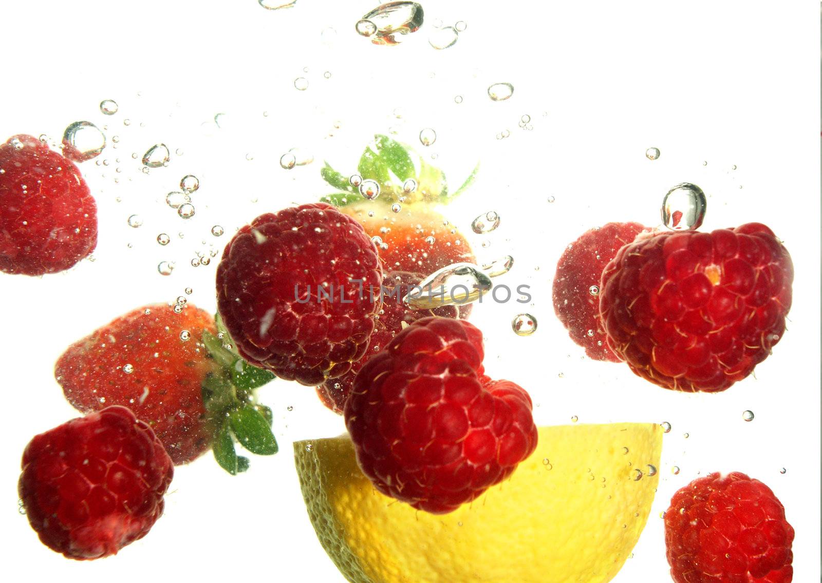 Splash of fresh fruit to water with bubbles of air