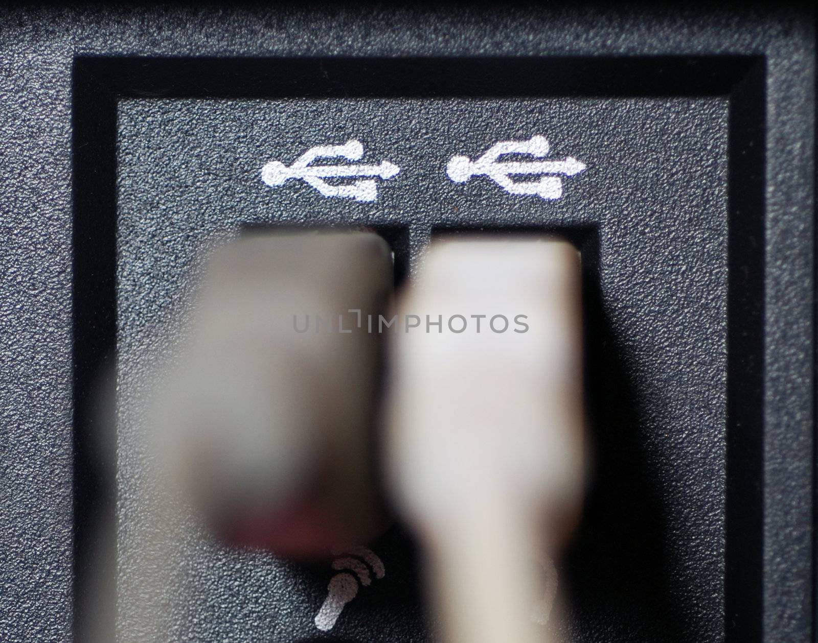 A close-up photograph of USB cable ports with cables