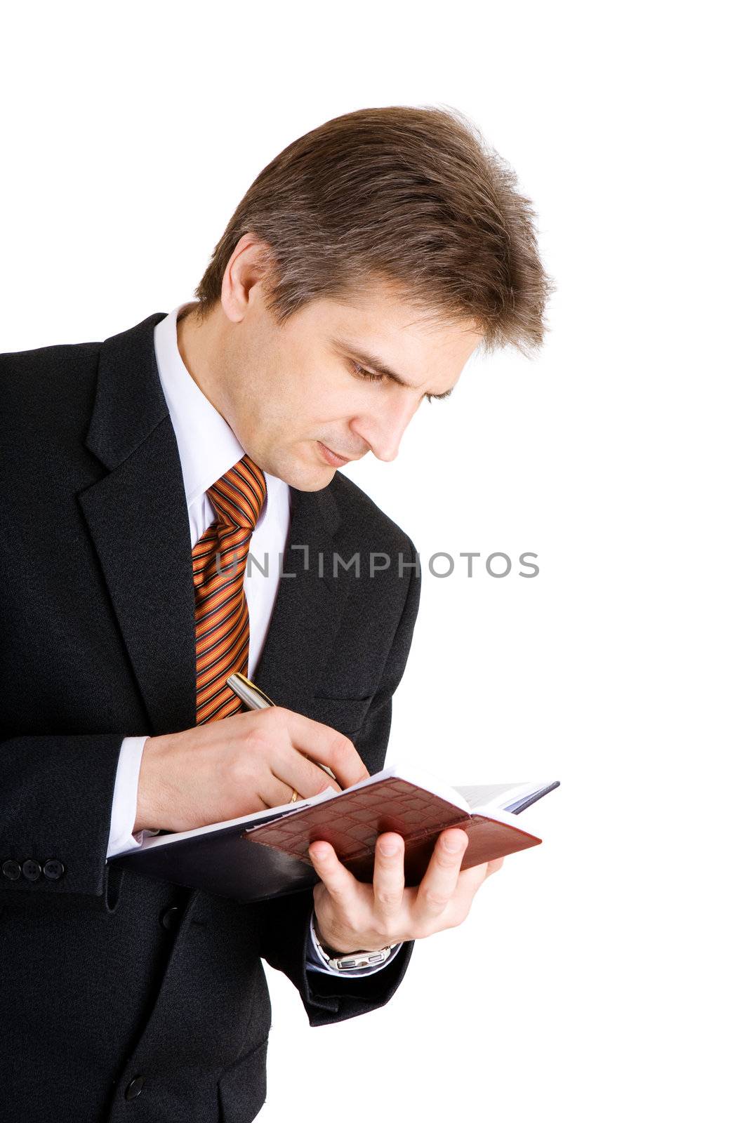 businessman writing something in his notebook