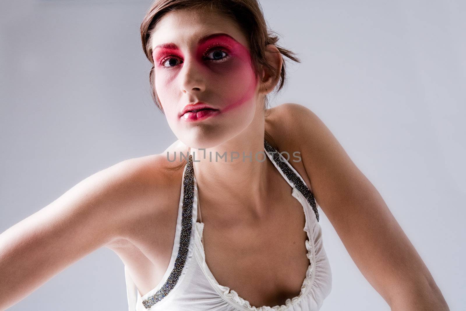 Close studio portrait of a pretty brunette with special artistic cosmetics