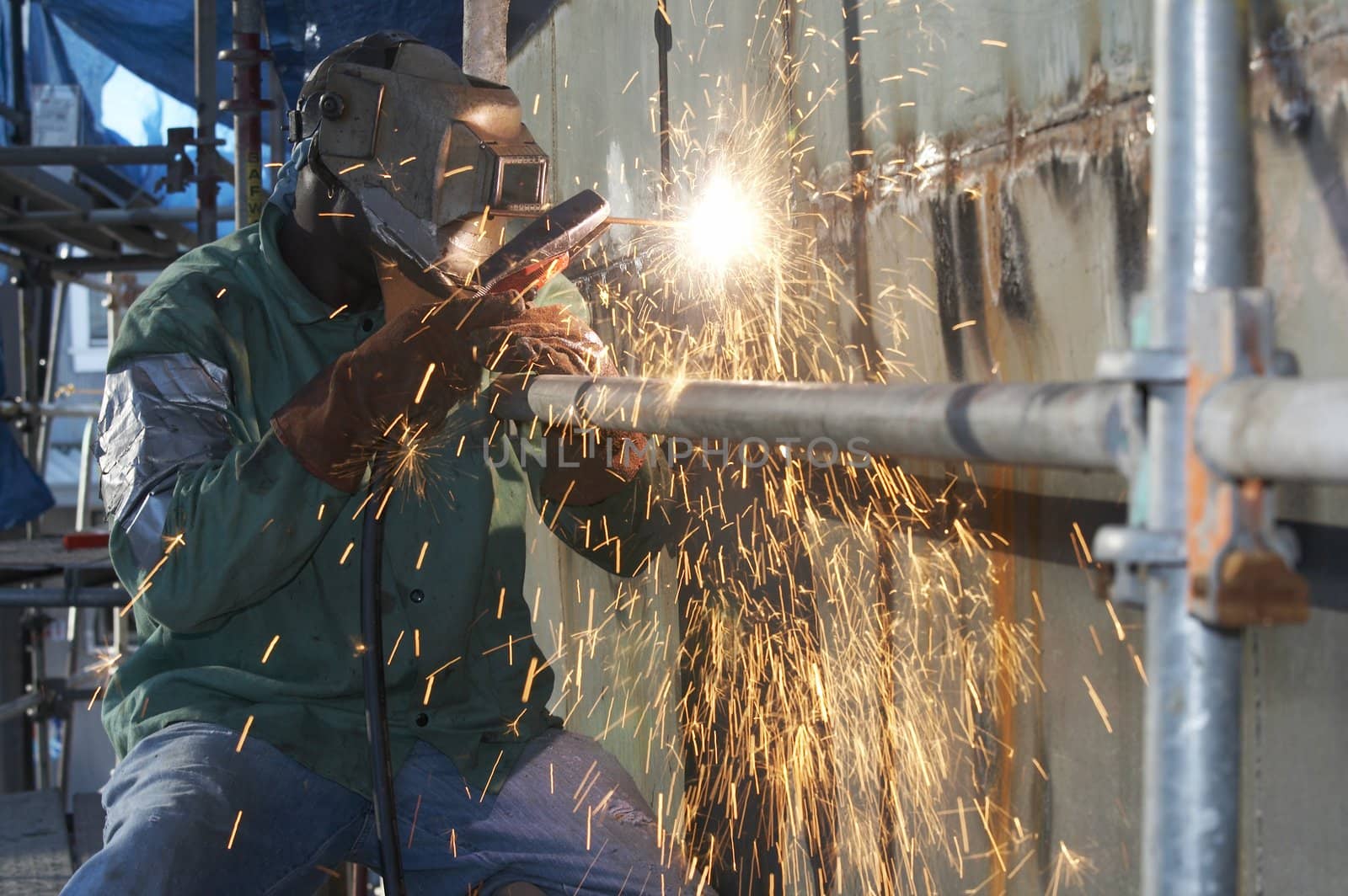 a welder working at shipyard during day shift