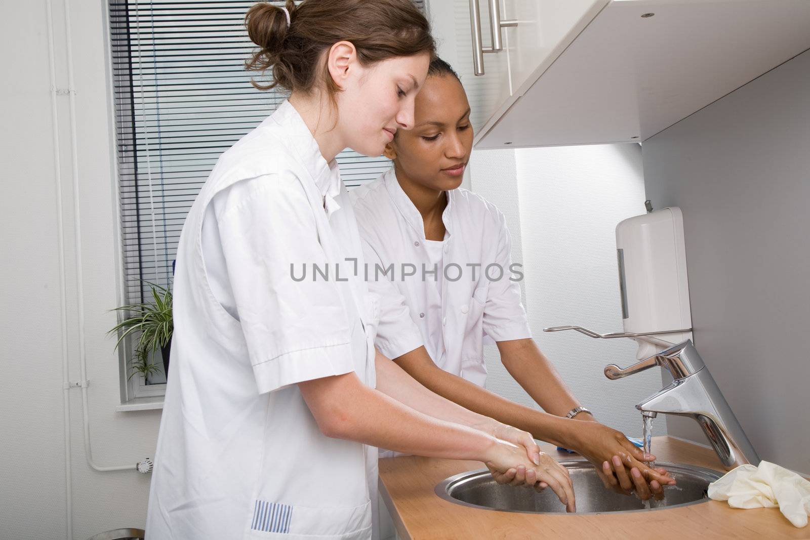 Two medical students washing their hands thoroughly