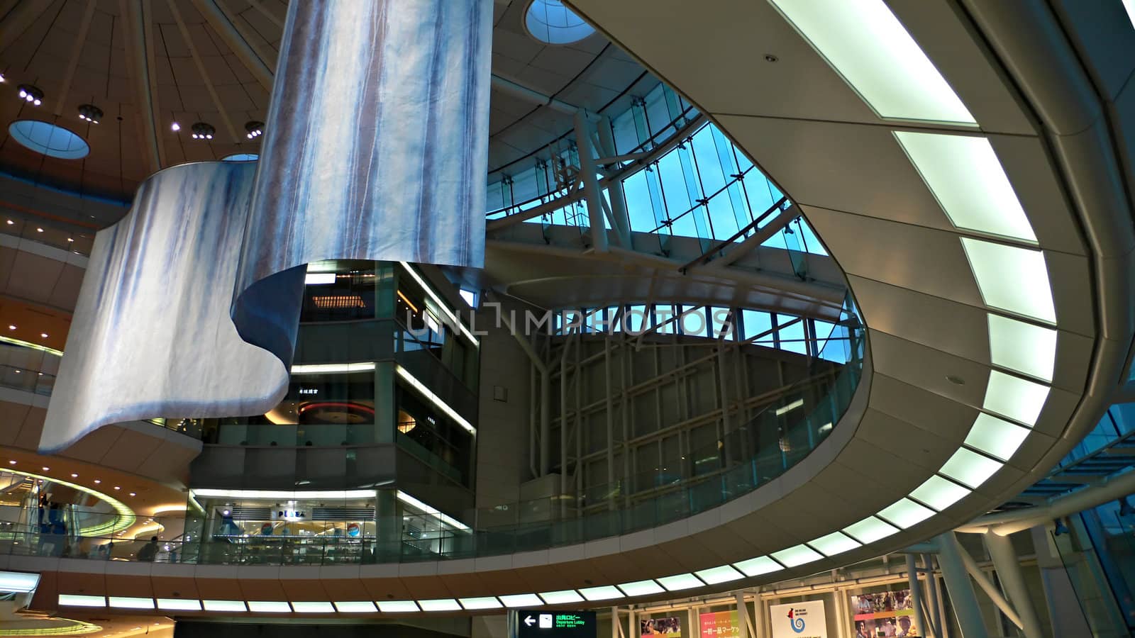 futuristic atrium environment, glass wall and metallic construction inside big public hall with sitting man