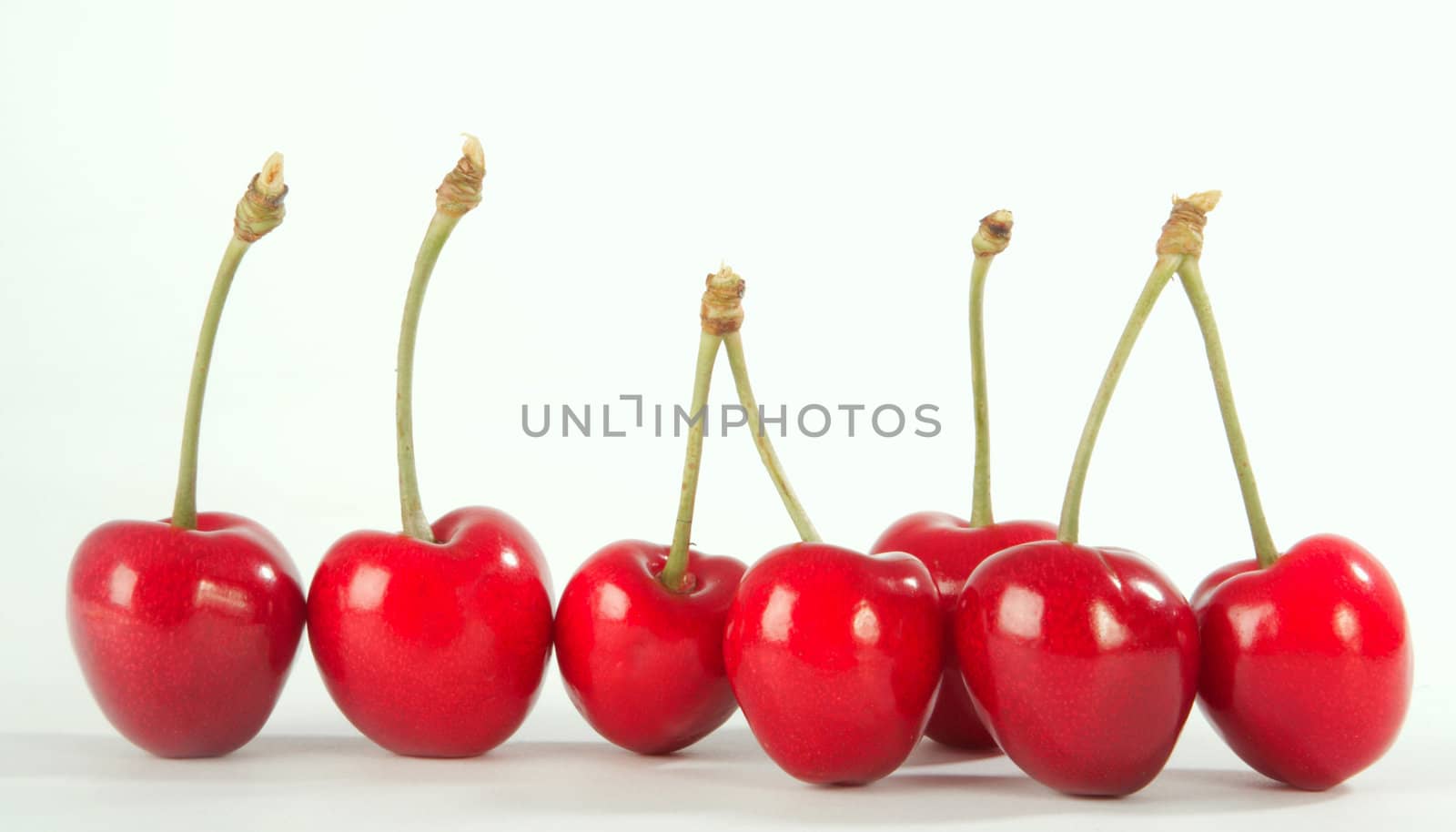 Ripe berries of a sweet cherry on a white sheet