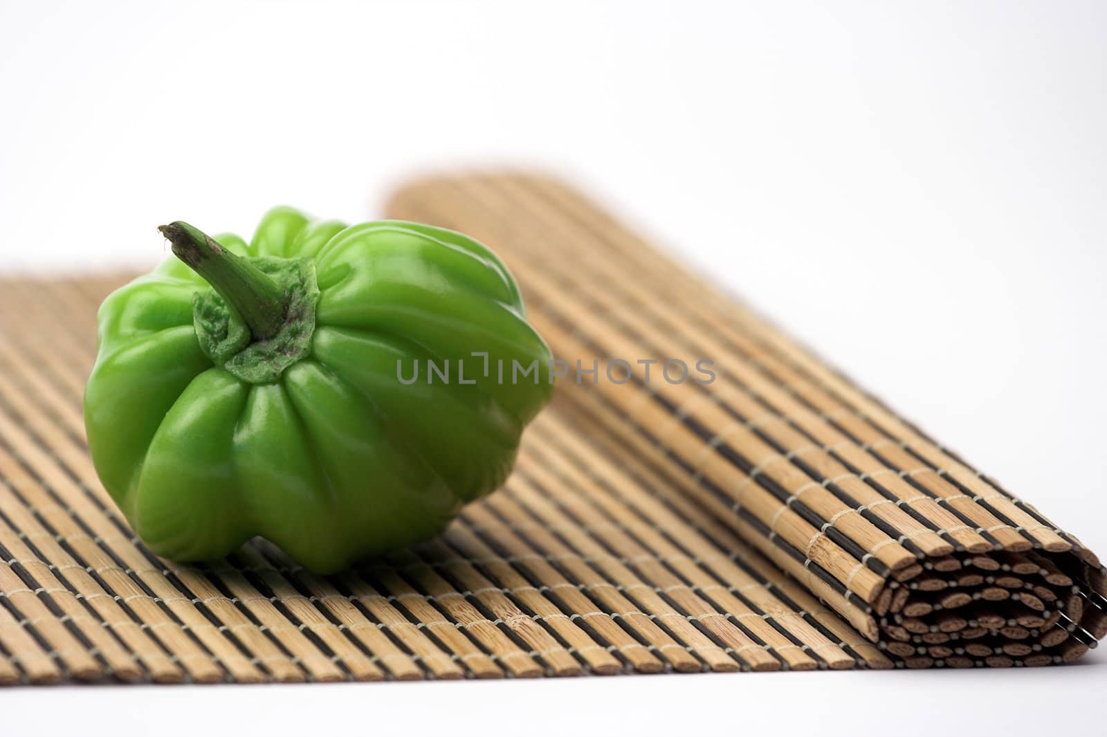 Green pepper over bamboo mat