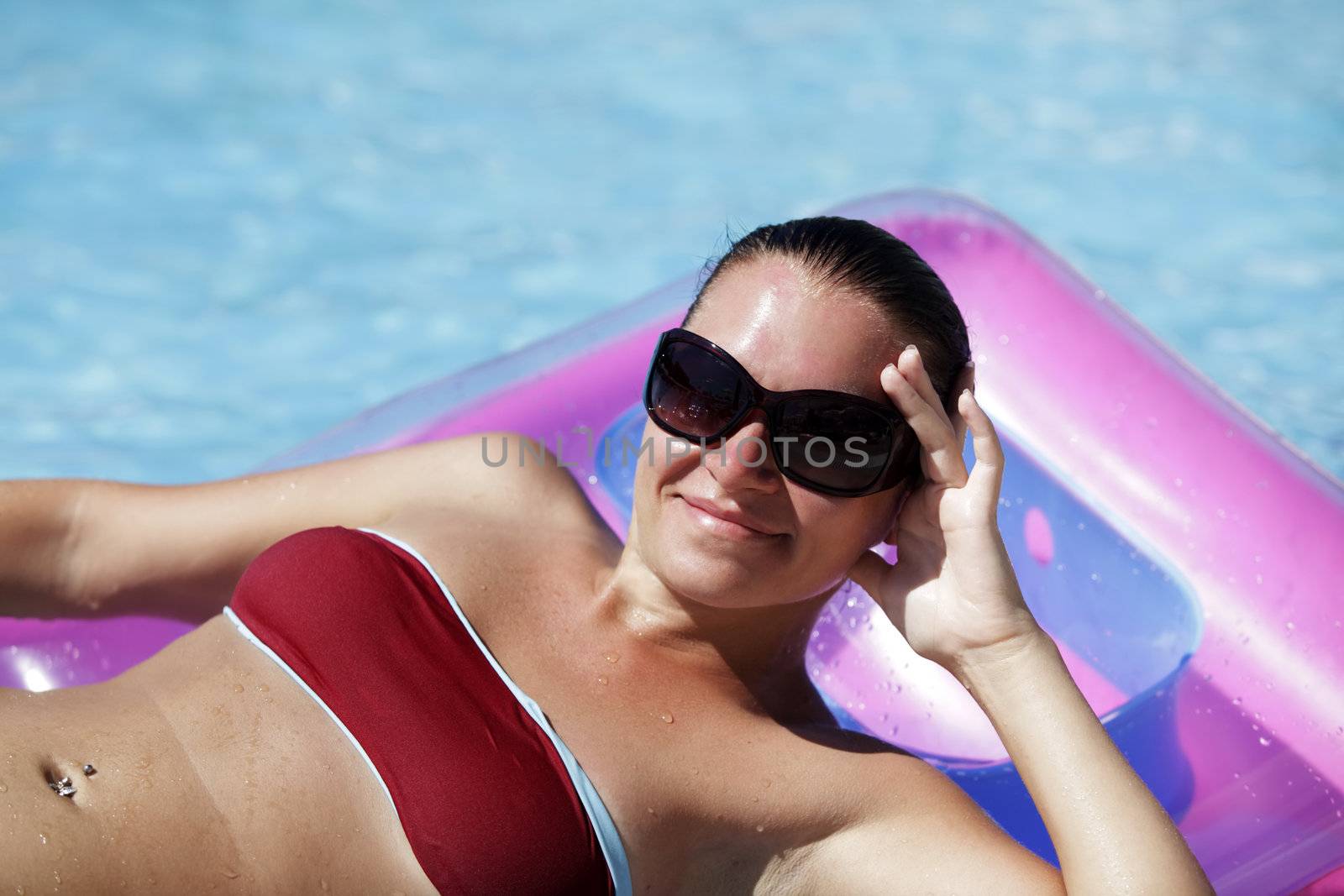 Beautiful woman enjoying summer in the pool