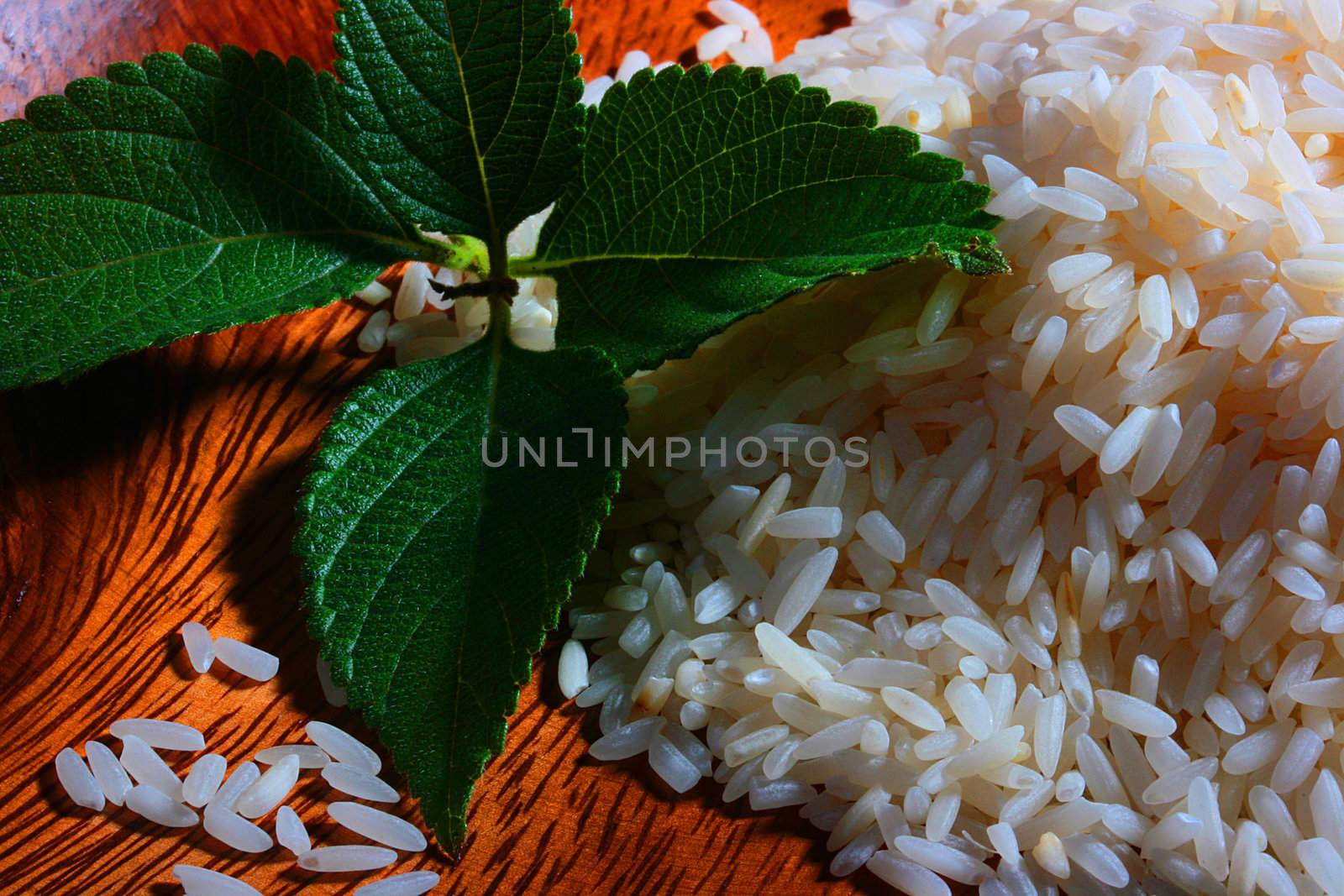 Rice in a wooden plate with mint leaves.