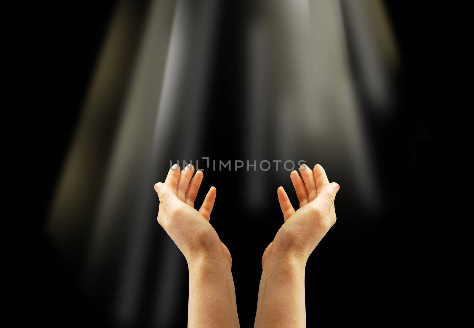 Hand and a light on the black background