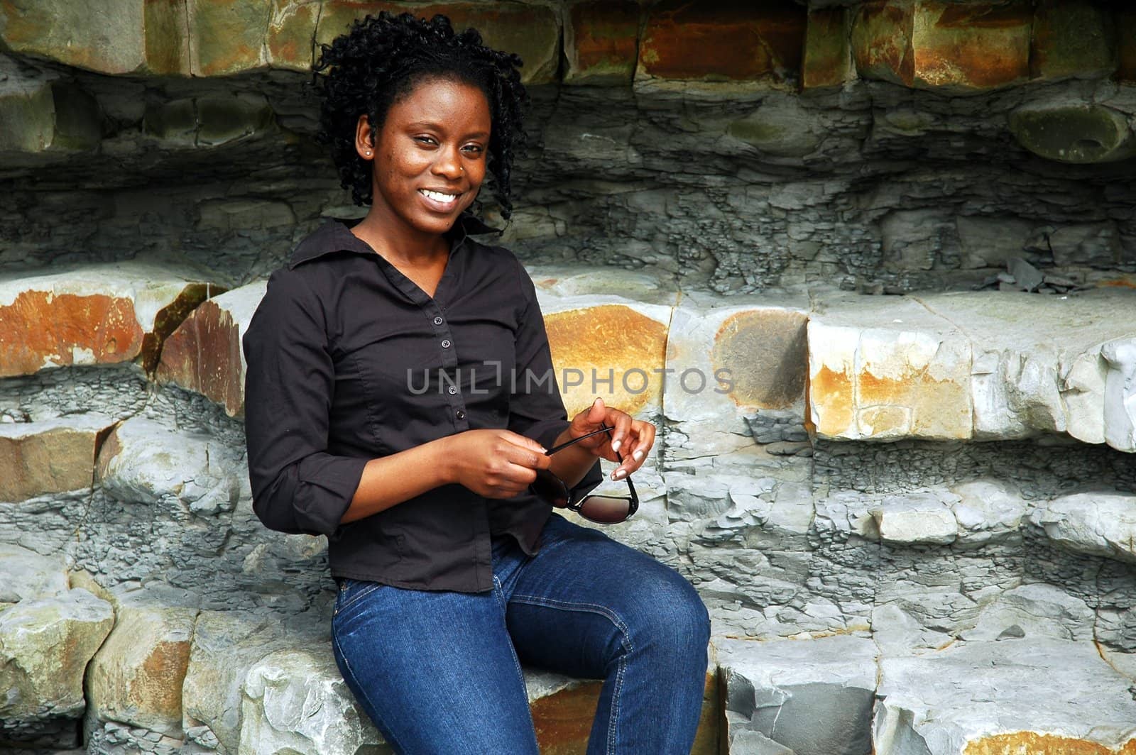 african girl in front of rock, horizontallyframed picture
