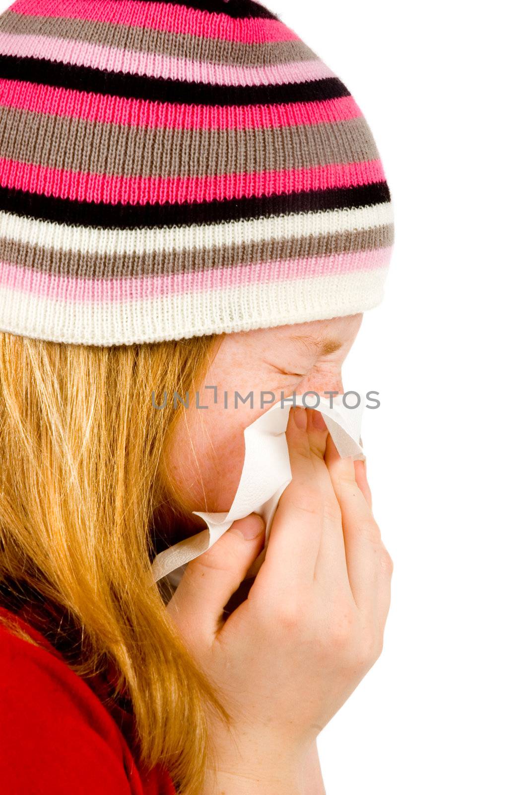 Young red girl blowing her nose - isolated on white