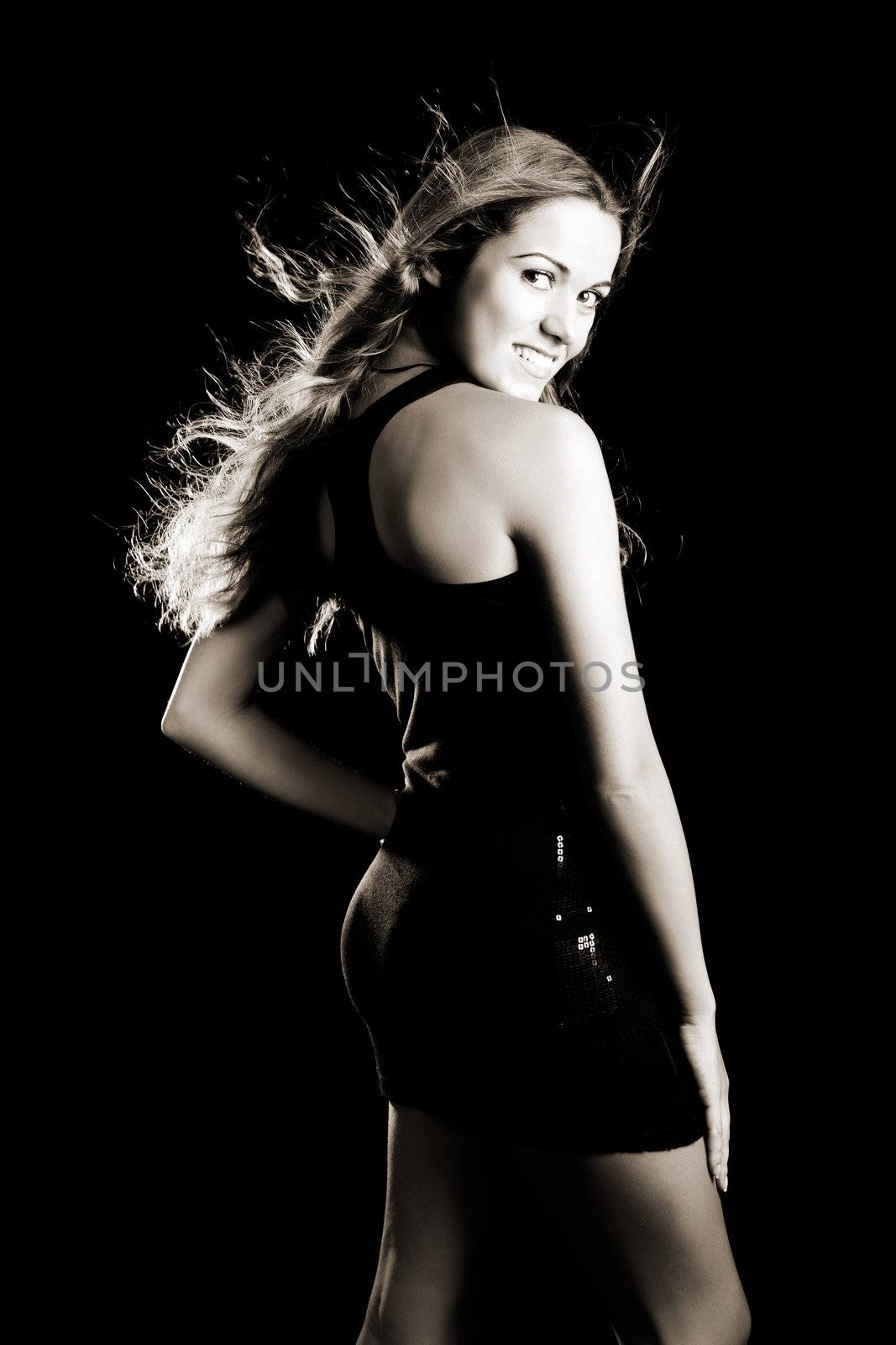 Studio portrait of a beautiful young fashion woman posing on a black background