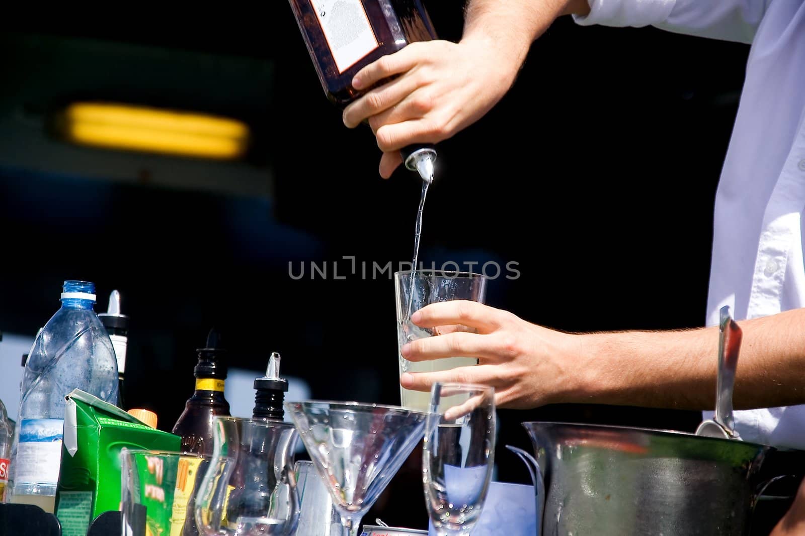 Hands of the barman mixing an alcoholic cocktail