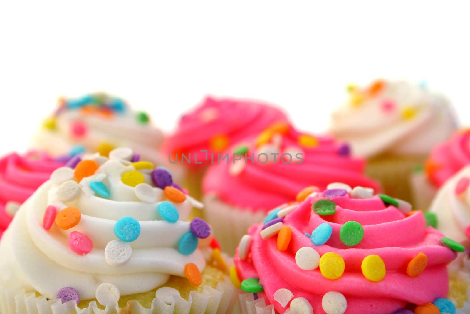 pink and white cupcakes with sprinkles

