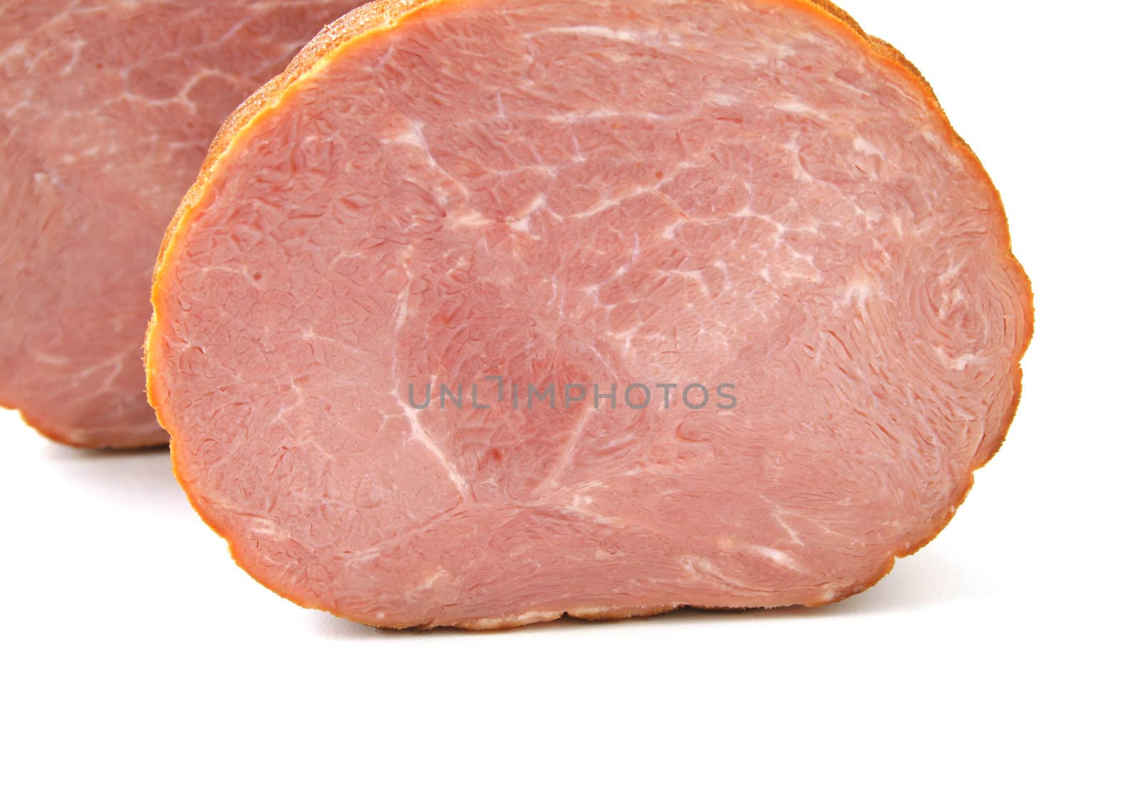 Baked ham cut in two isolated on a white background