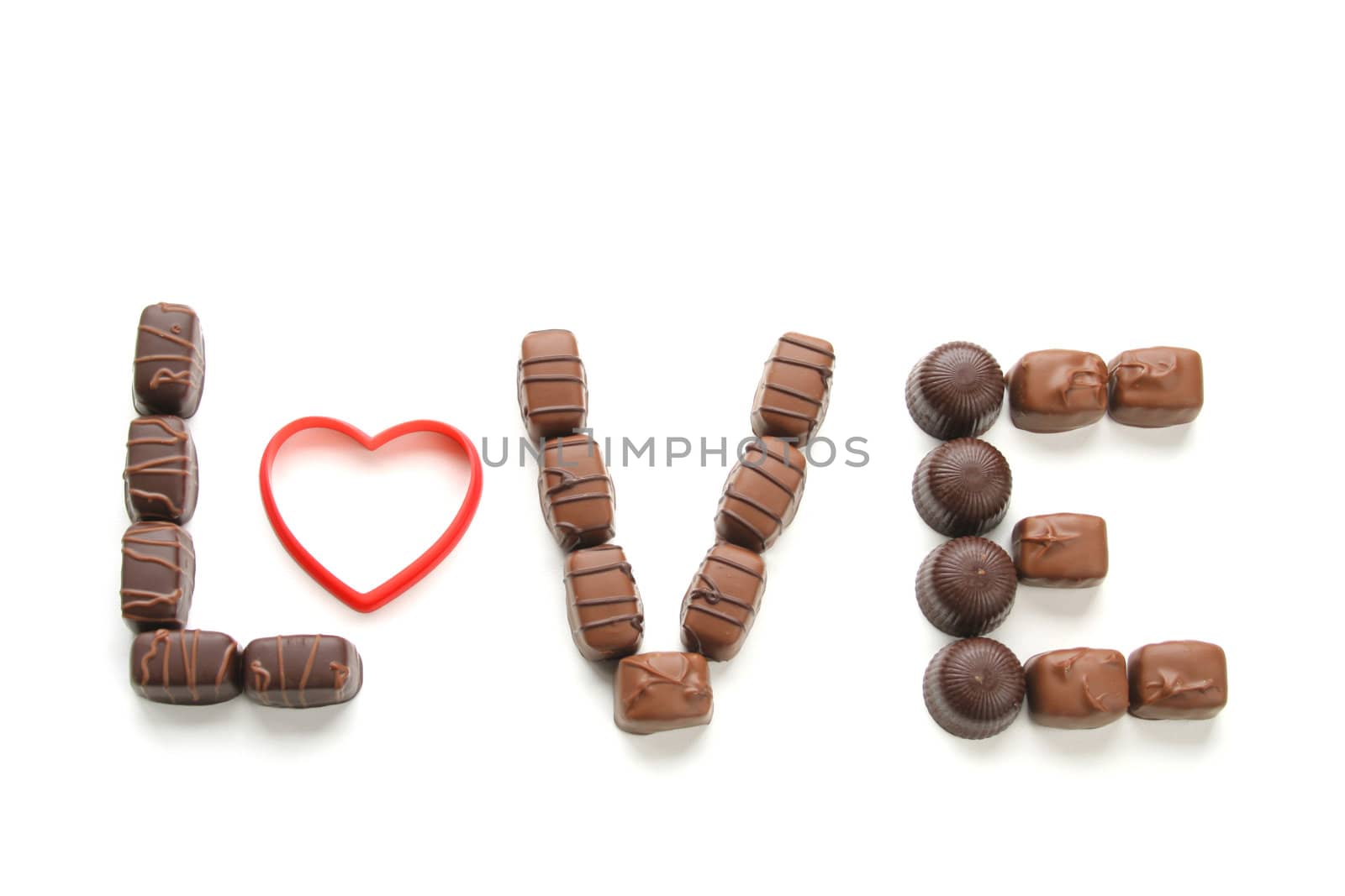 Chocolate candy isolated on a white background spelling out the word love.
