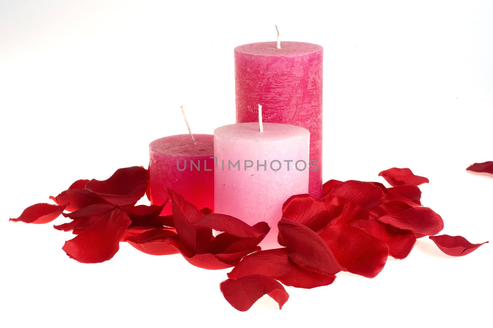 three candles and a lot of rose-leaves