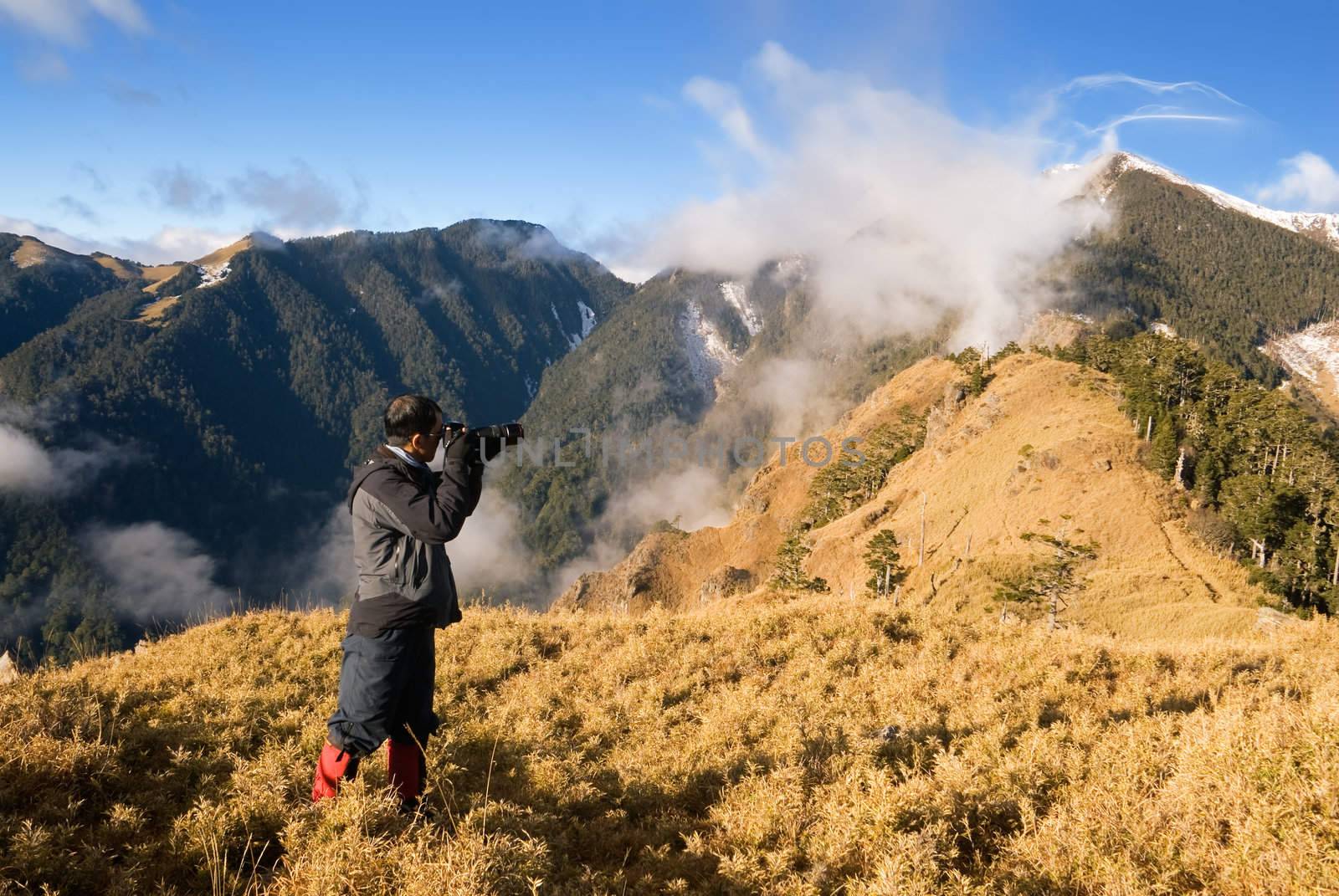 Outdoor photographer with dramatic mountain scenery in Taiwan, Asia.