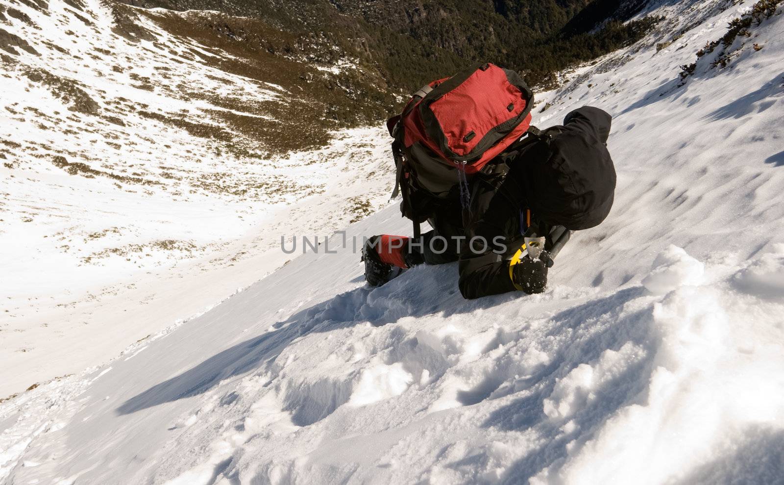 Mountaineer climb on dangerous snow slap of mountain.