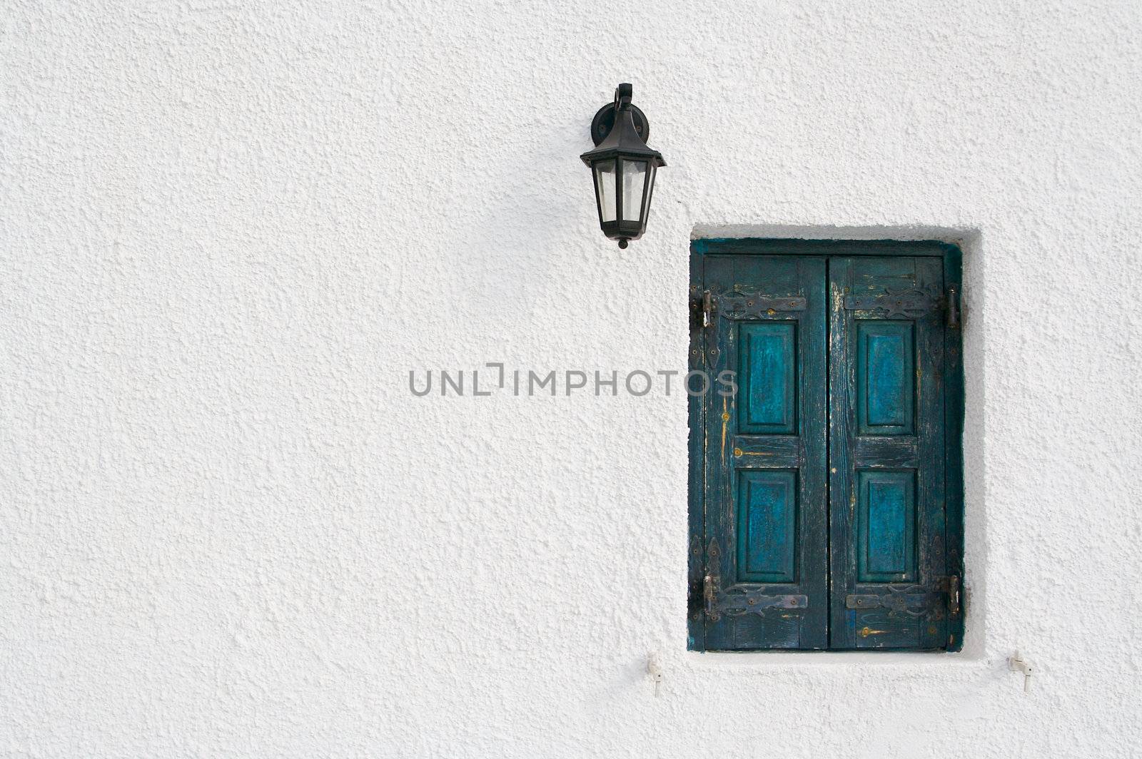 Abstract close-up of Santorini home wall, window and lamp. by Feverpitched