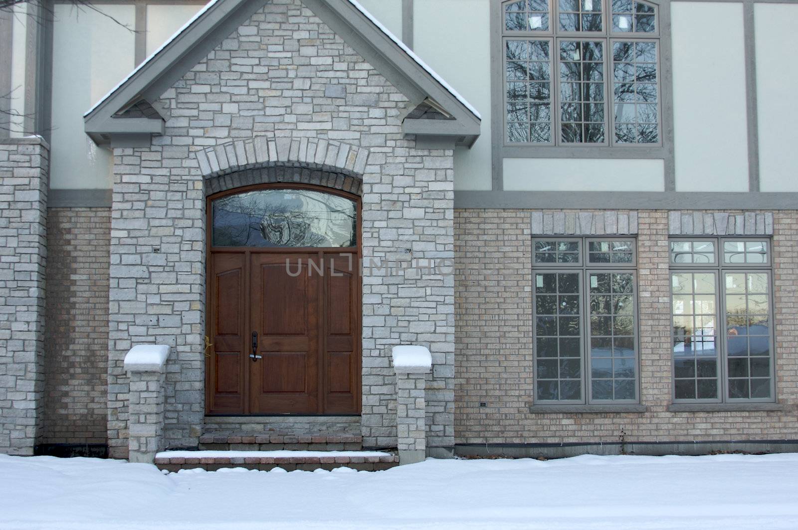 Majestic Newly Constructed Home Facade on a Blustry Winter Day