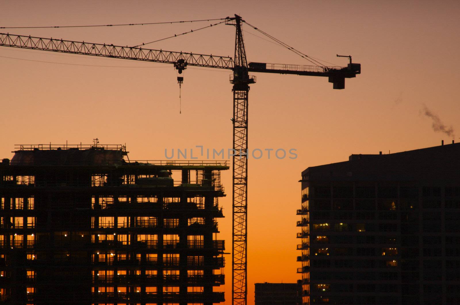 Silhouette of Crane and Building Construction Site