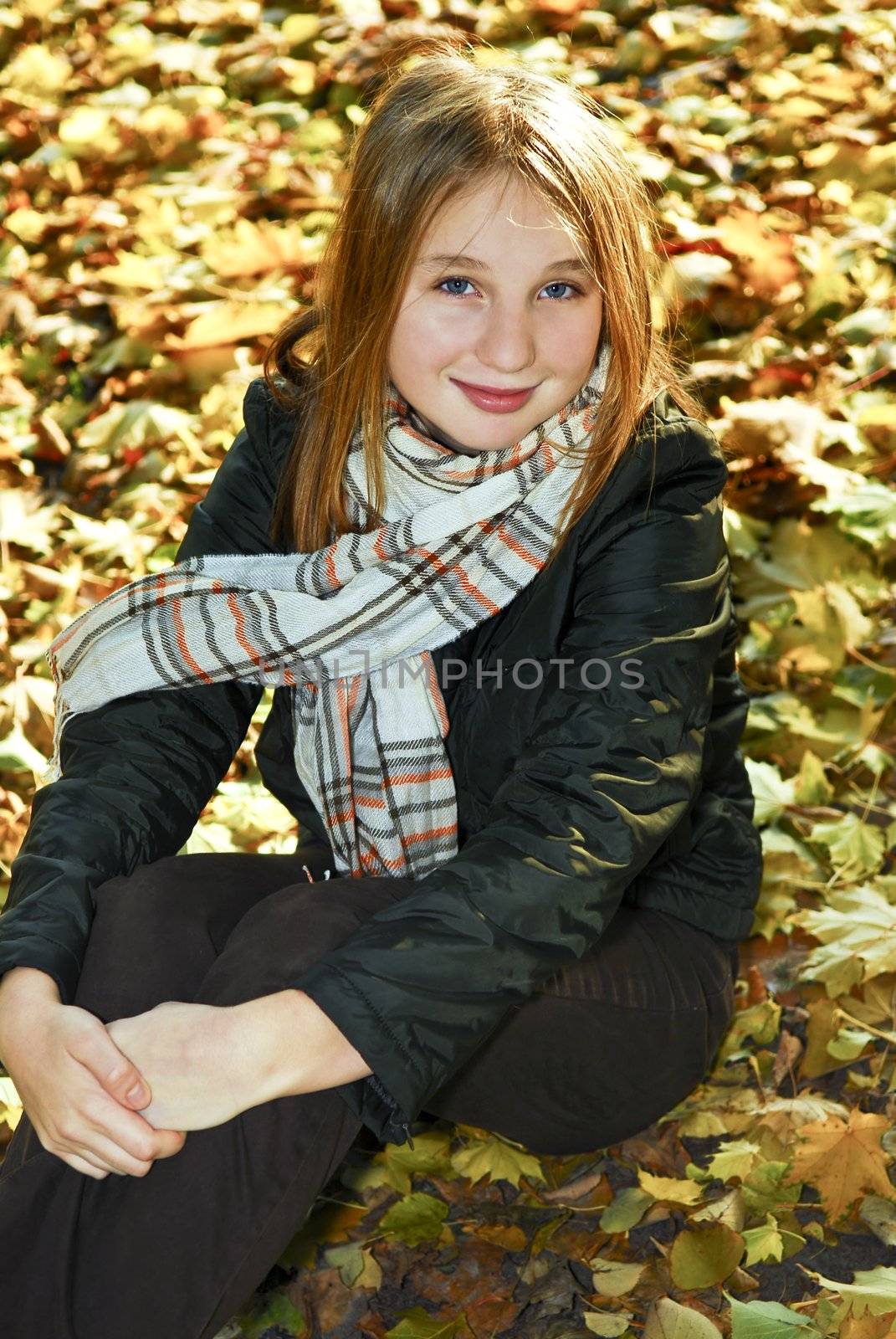 Portrait of a beautiful teenage girl in fall park