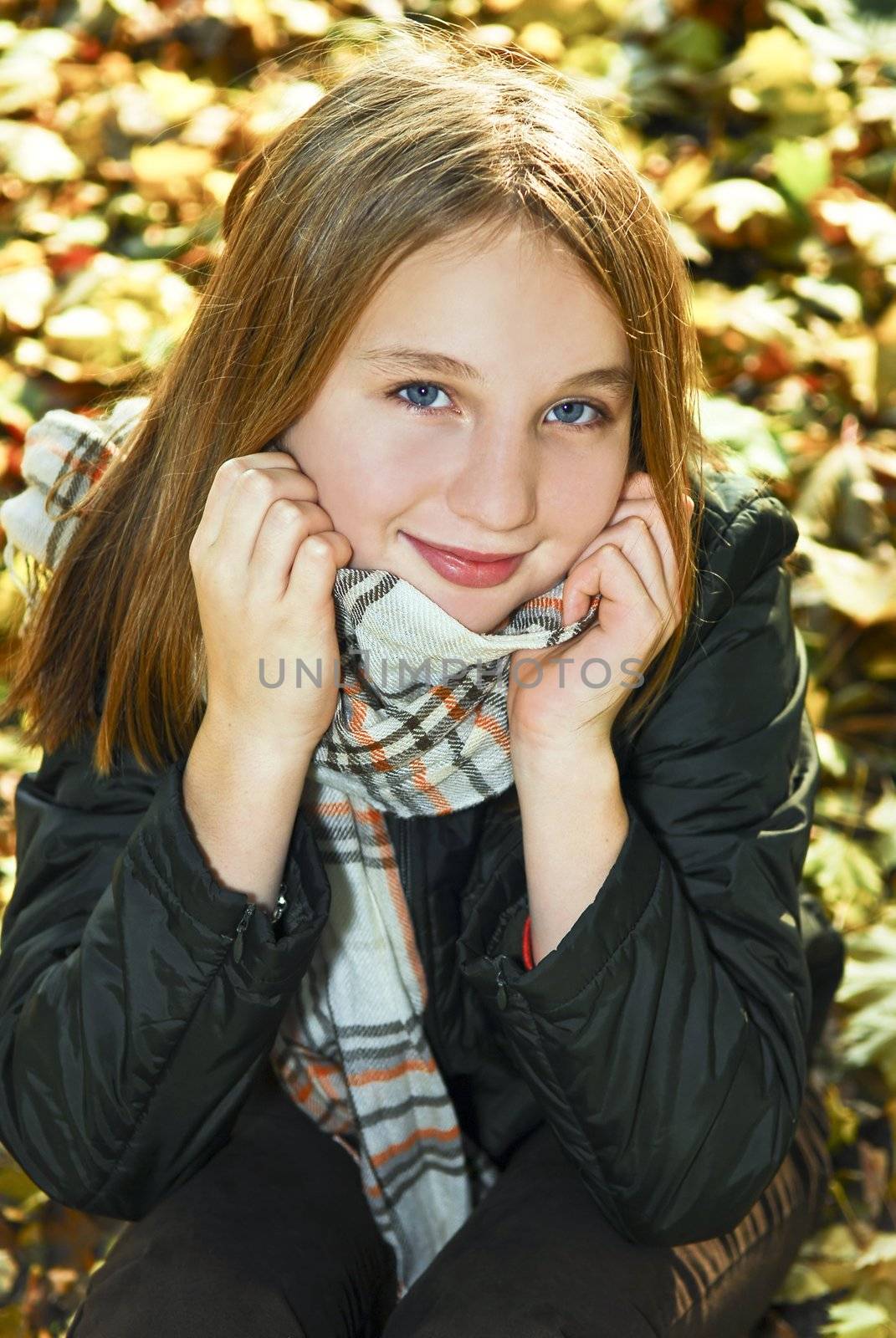 Portrait of a beautiful teenage girl in fall park