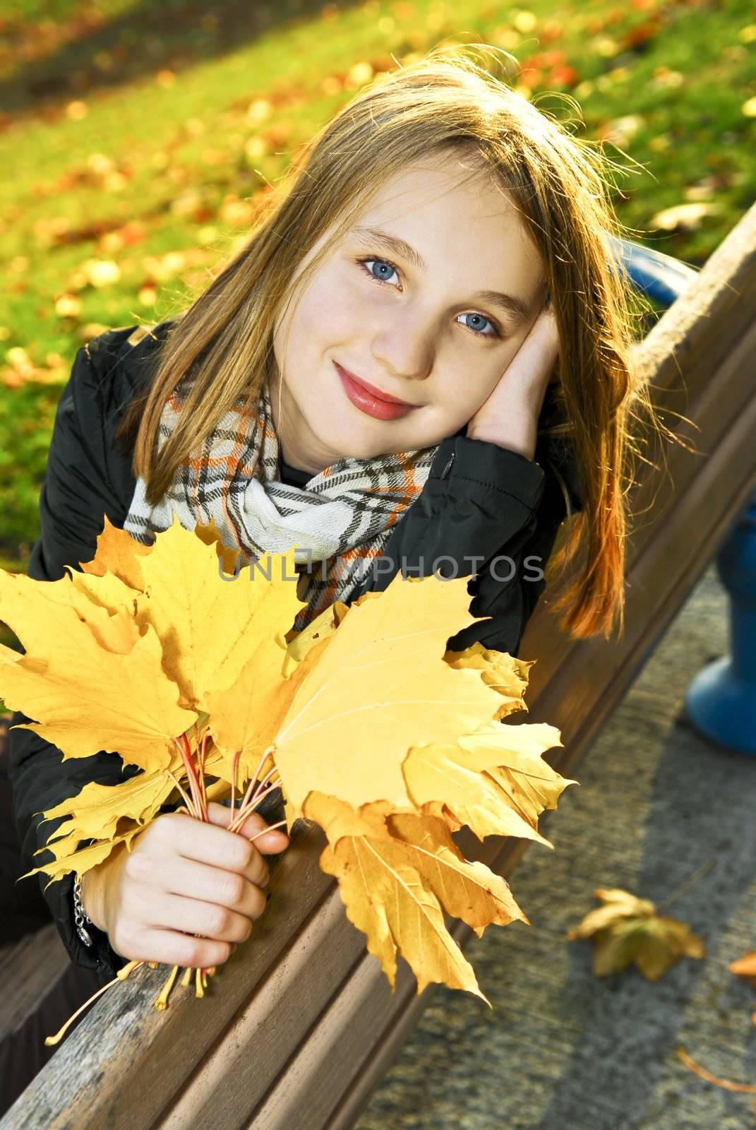 Portrait of a beautiful teenage girl in fall park