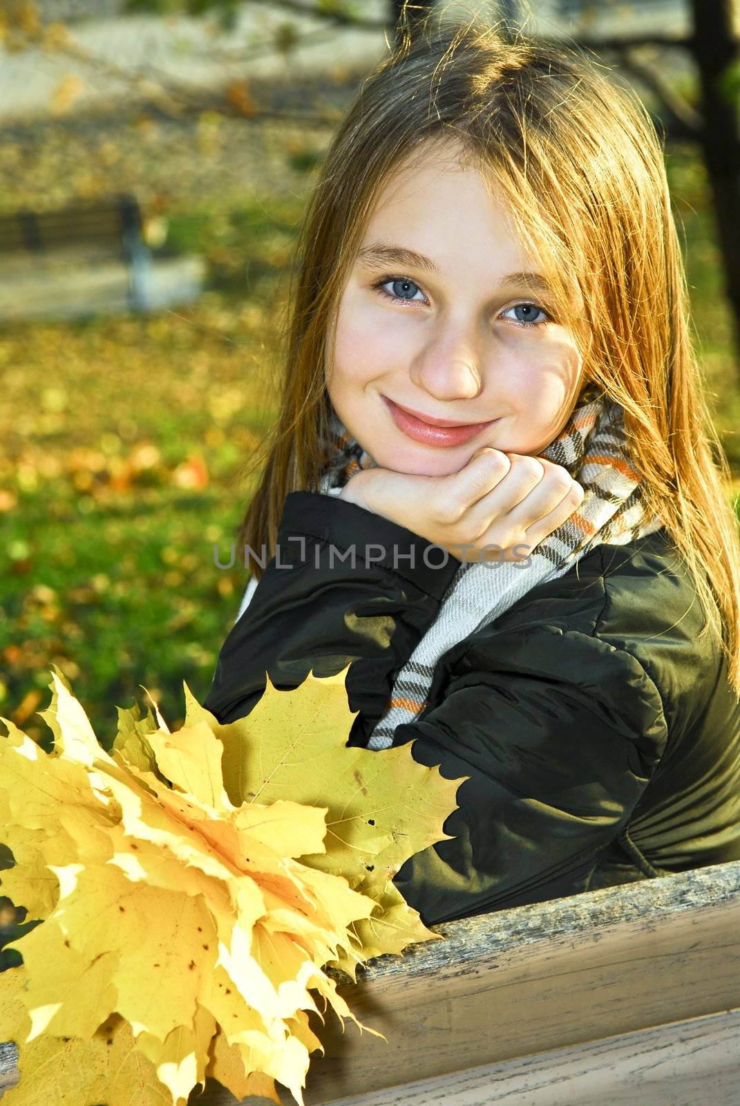 Portrait of a beautiful teenage girl in fall park