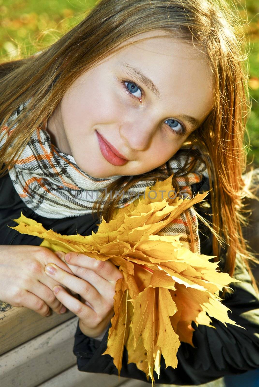 Portrait of a beautiful teenage girl in fall park