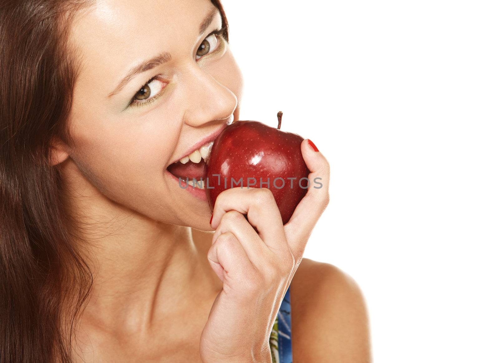 Face of young woman biting the red apple