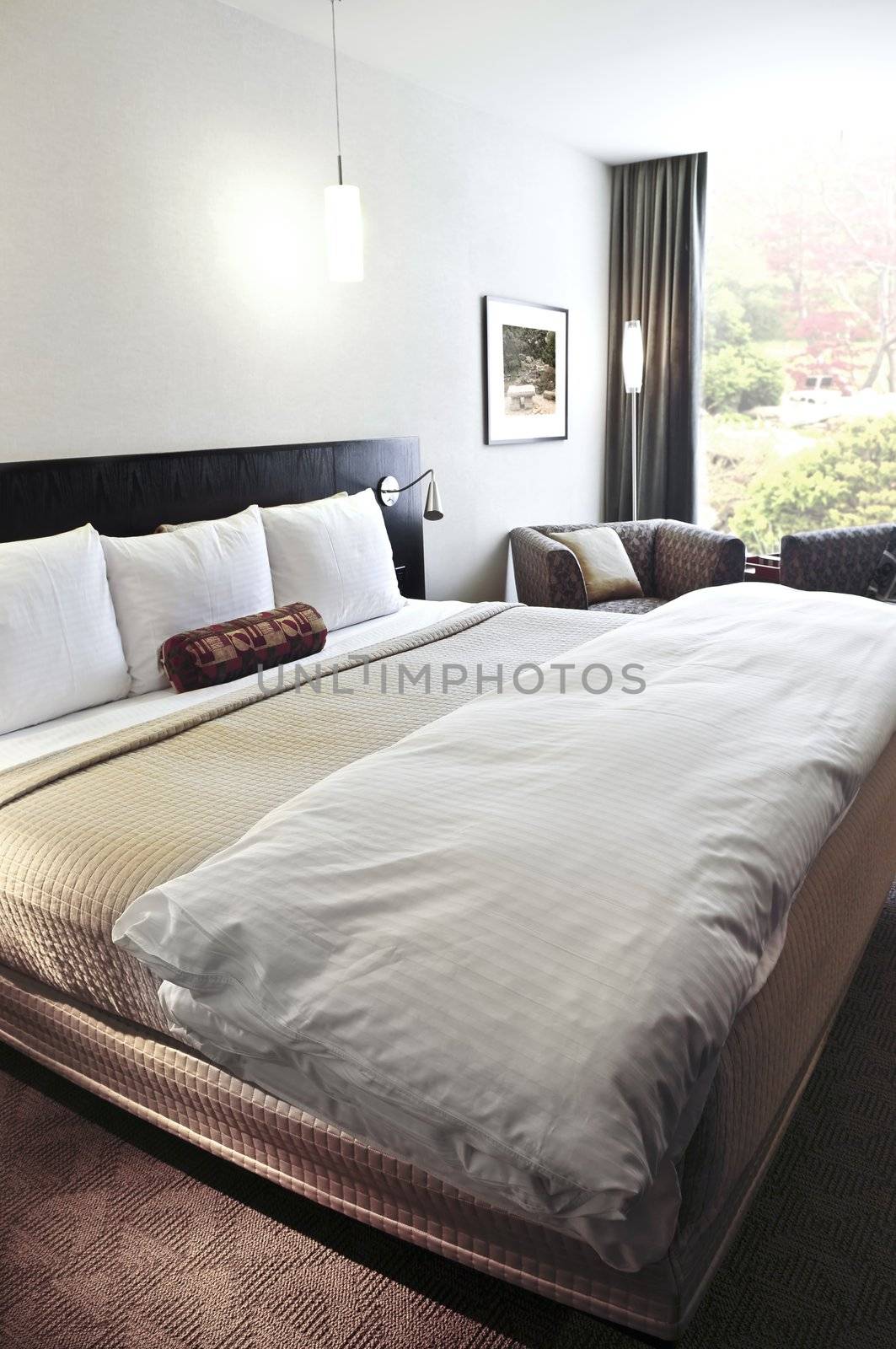 Bedroom with comfortable bed in neutral colors