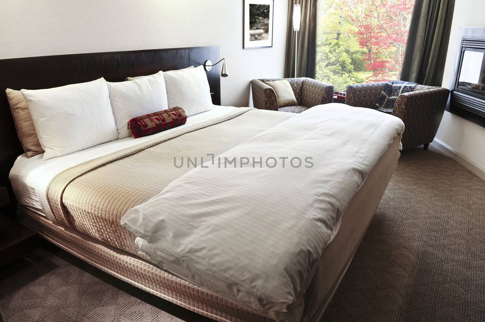 Bedroom with comfortable bed in neutral colors