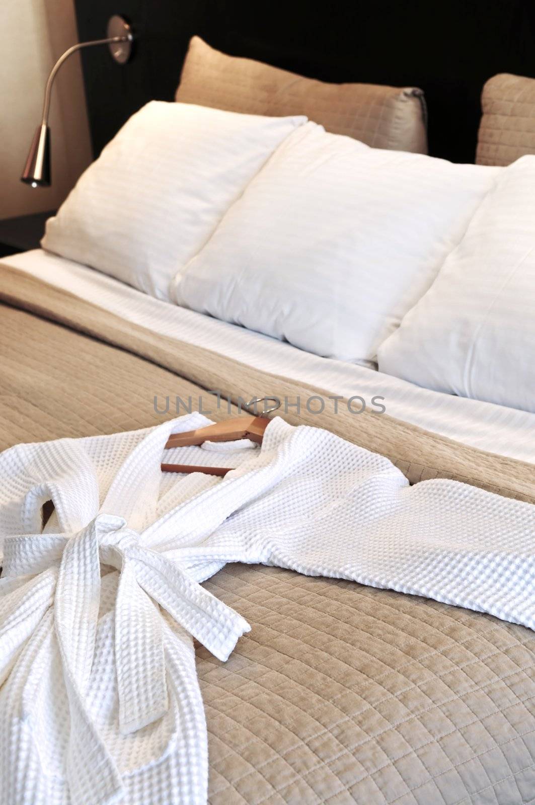 Hotel bed with bathrobe by elenathewise