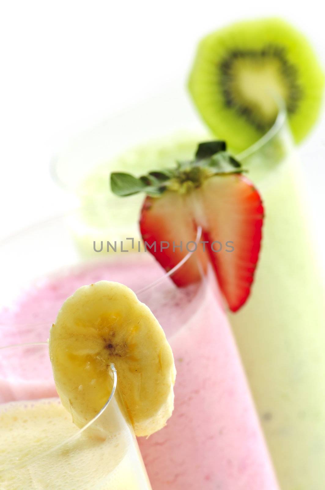 Assorted fruit smoothies close up on white background