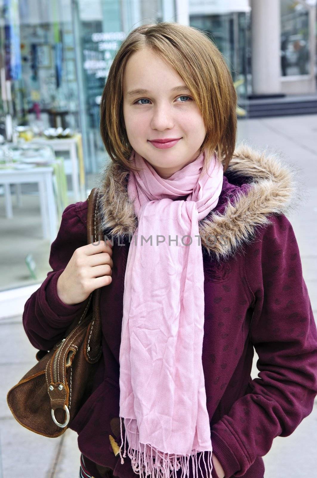 Teenage girl window shopping on city street