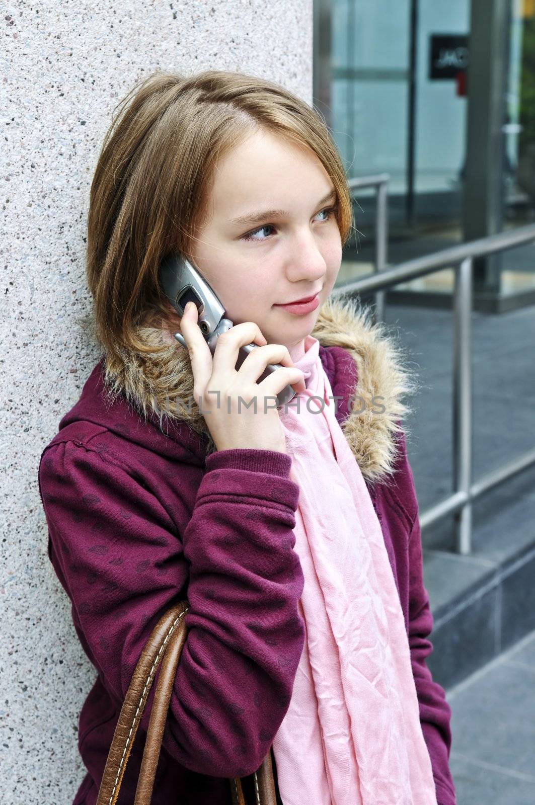 Teenage girl talking on cell phone outside