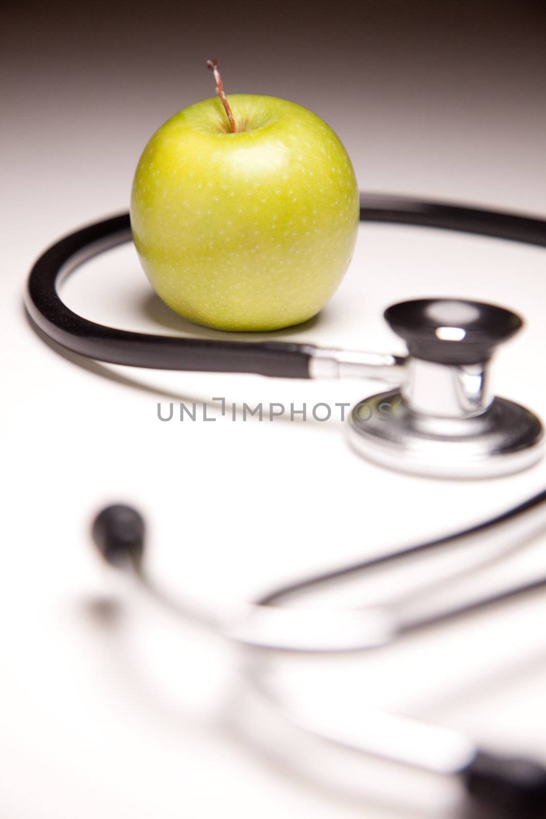 Stethoscope and Green Apple on Gradated Background by Feverpitched