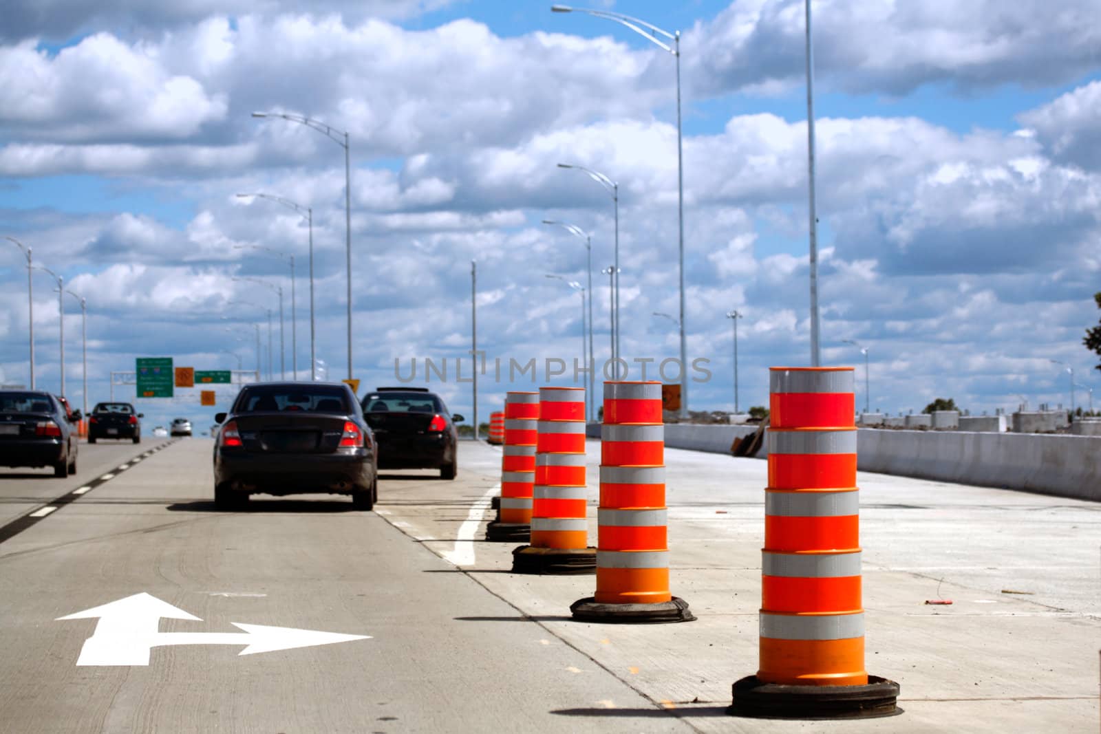 Highway exit with roadwork barrels