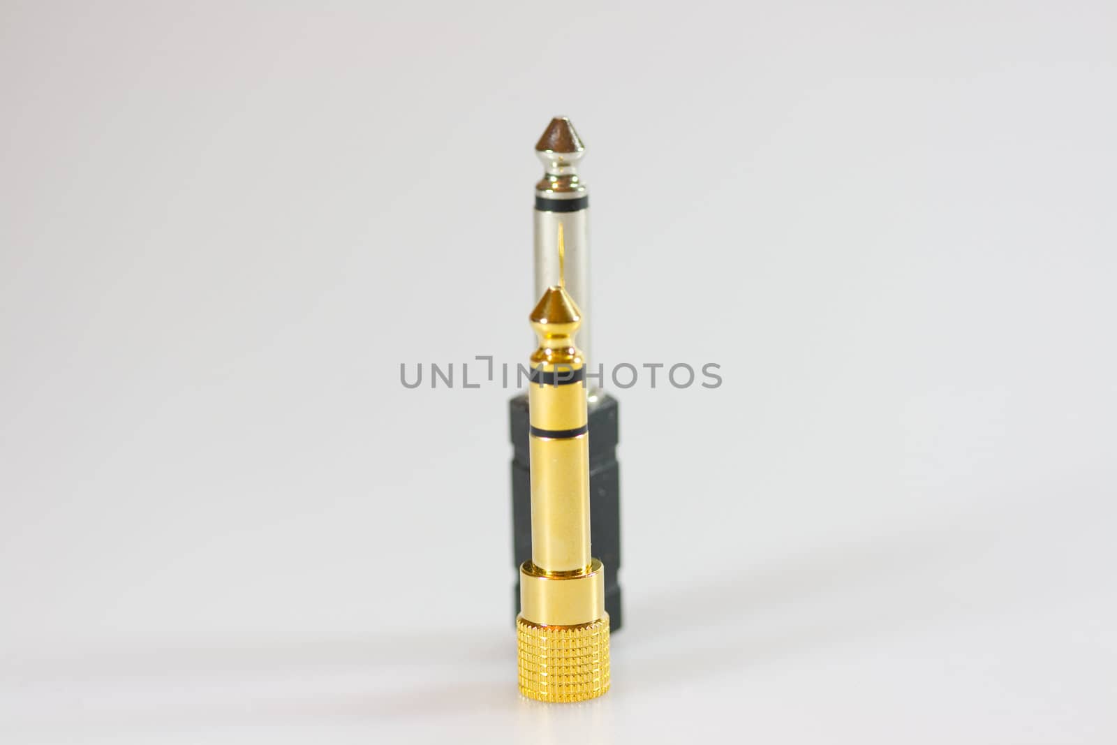 Gold and black adapter on gray background