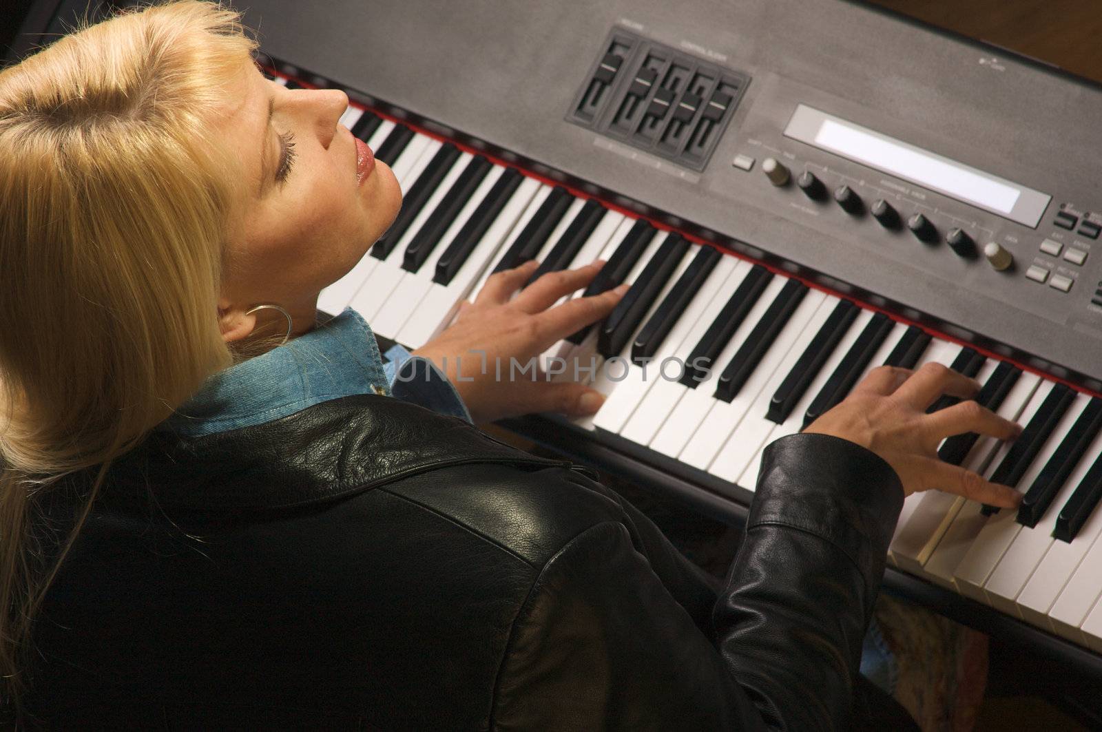 Femal Musician Sings While Playing Digital Piano