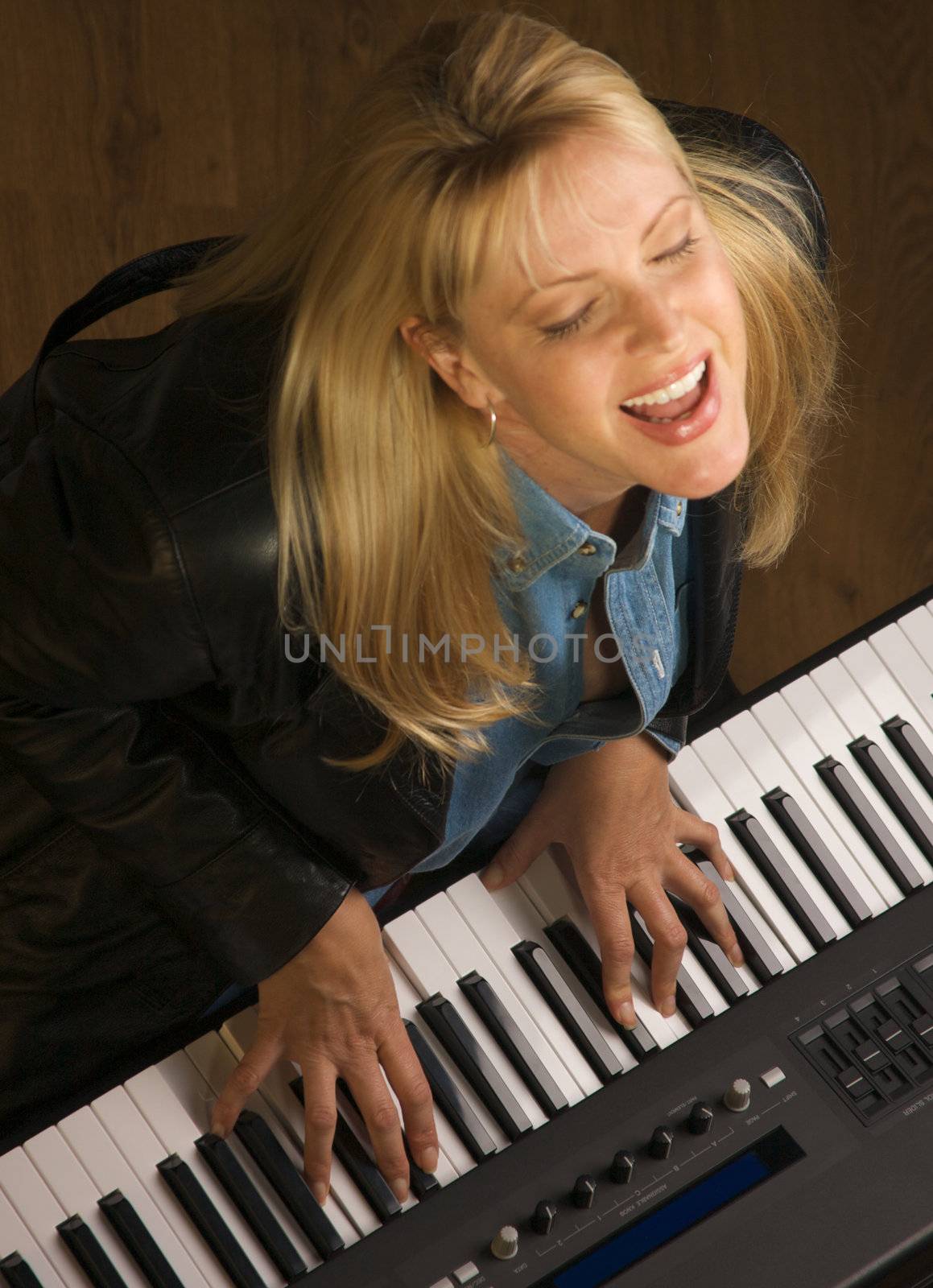 Femal Musician Sings While Playing Digital Piano