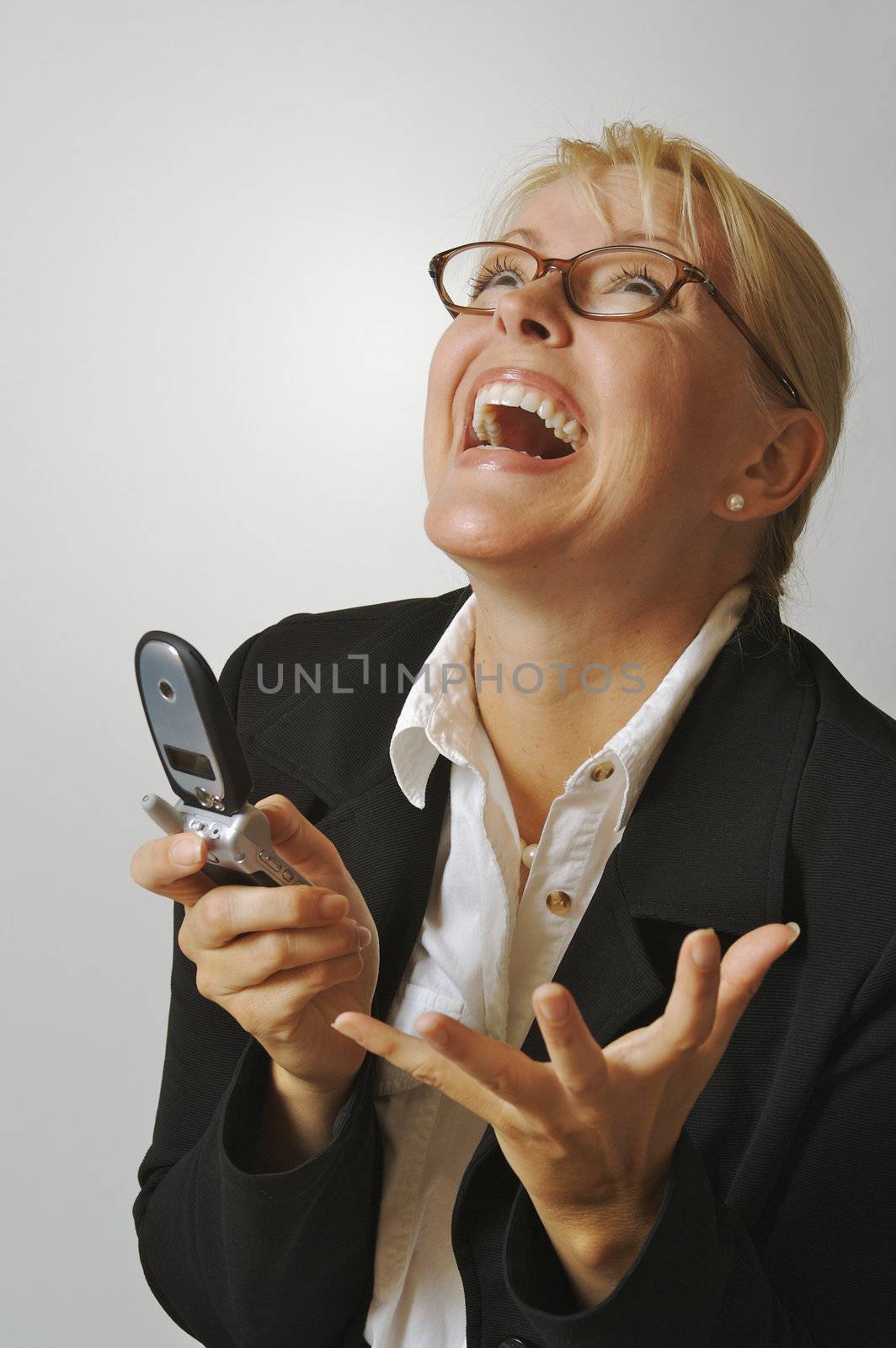 Elated Businesswoman Using Cell Phone by Feverpitched