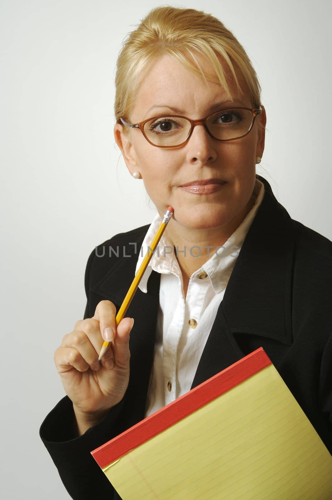 Beautiful Woman Thinks with Pencil & Notepad on a White Background.
