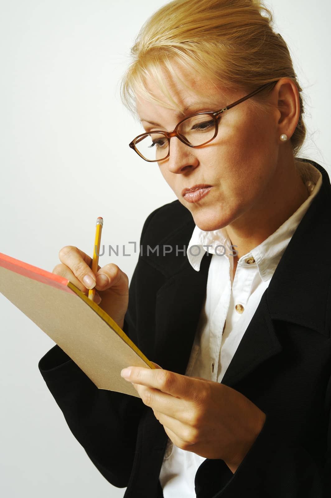 Beautiful Woman Thinks with Pencil & Notepad Taking Notes by Feverpitched