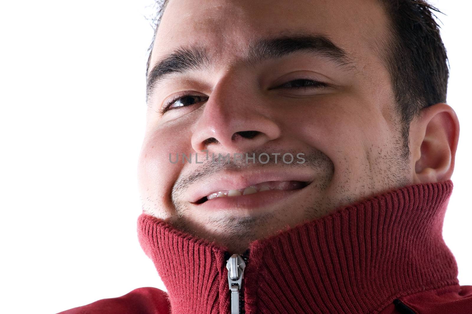 A young man covering his neck with his sweater because he is cold. A great concept for HVAC.