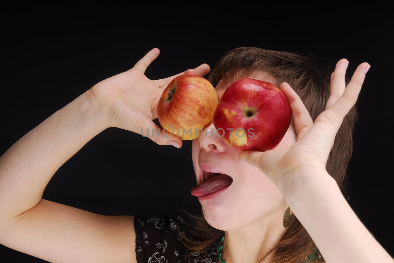 Woman with apple near her eyes